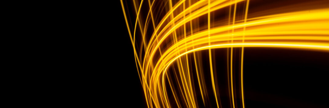 a long exposure photo of a yellow light trail on a black background. High quality